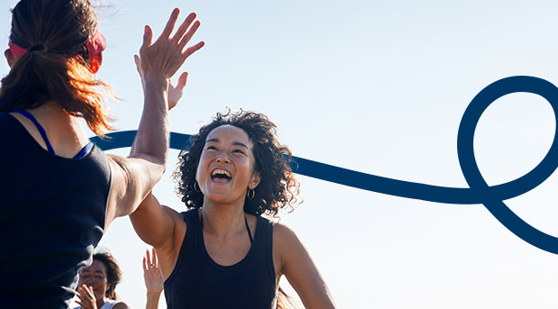 A group of people celebrating after a workout representing a good habit.